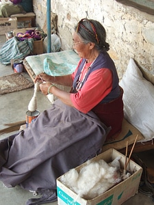 Tibetan woman spinning wool in Nepal photo