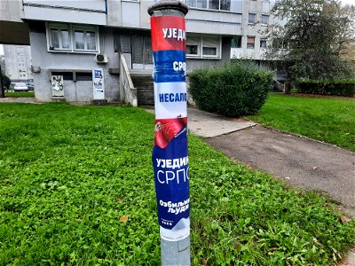 A lamppost with two posters of Ujedinjena Srpska