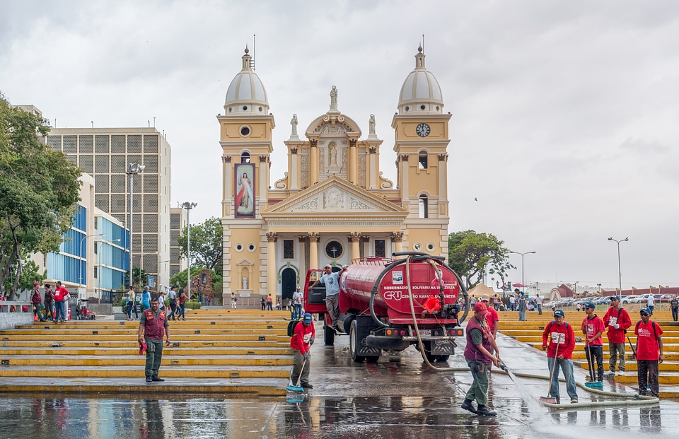 cleaning sidewalks of the square Chiquinquira Basilica