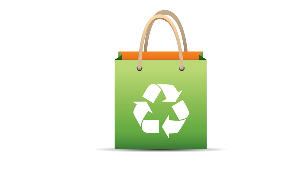 Green reusable shopping bag with recycle symbol