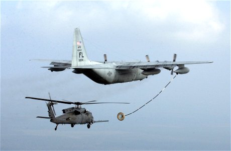 HH-60 fuels off a C-130 Tanker