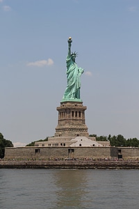 Front view of Statue of Liberty with cloudy blue sky