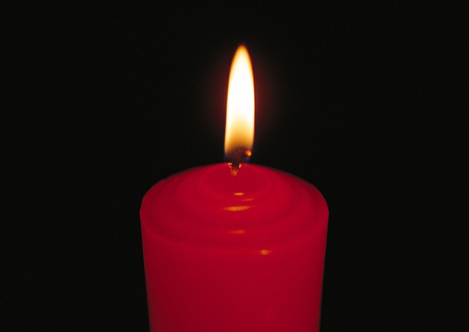 yellow candle on black background