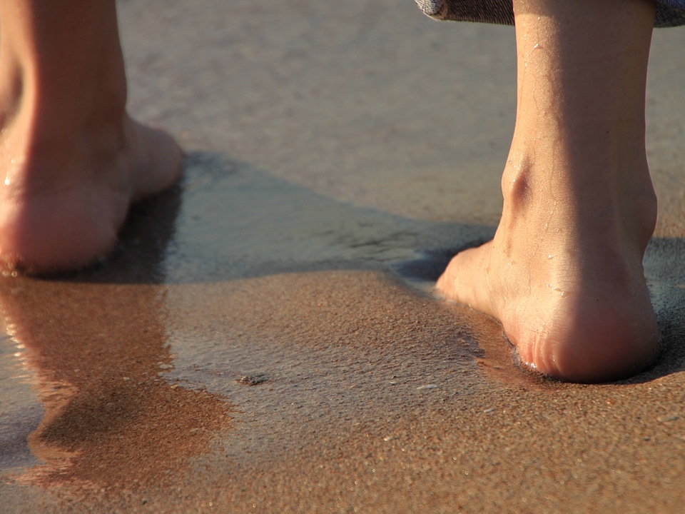 Girl’s Barefoot Legs on the Beach