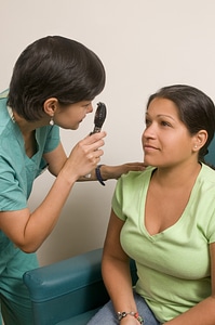 A Female Doctor Examining A Patient photo