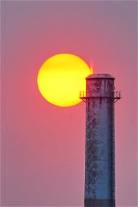 smokestack at sunset off the ct river