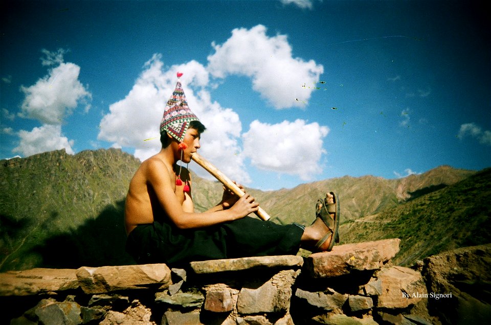 Bolivian boy playing flute, Potosi