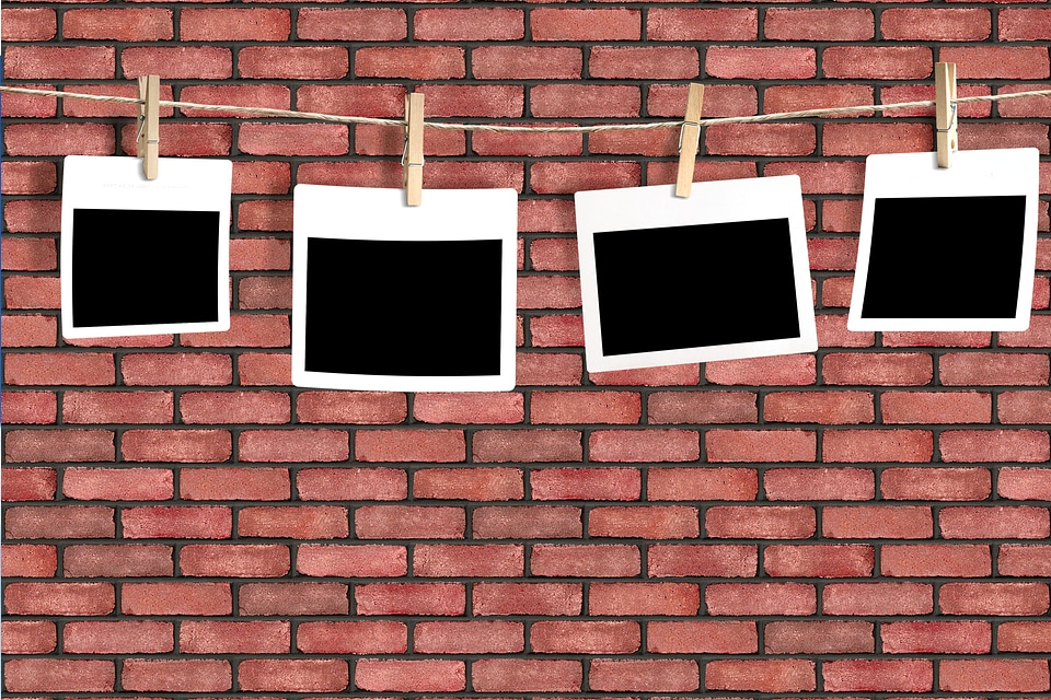 photos on a rope isolated on brick wall