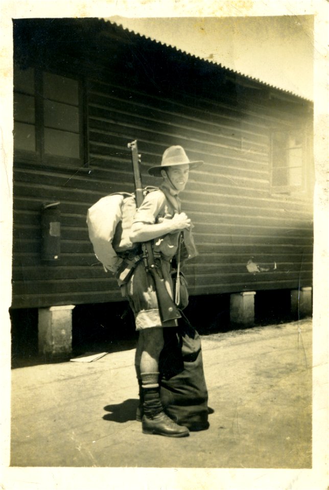 Soldier packed and ready outside barracks, probably in either Darwin or PNG.