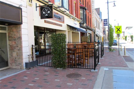 Sidewalk patio and bicycle post.