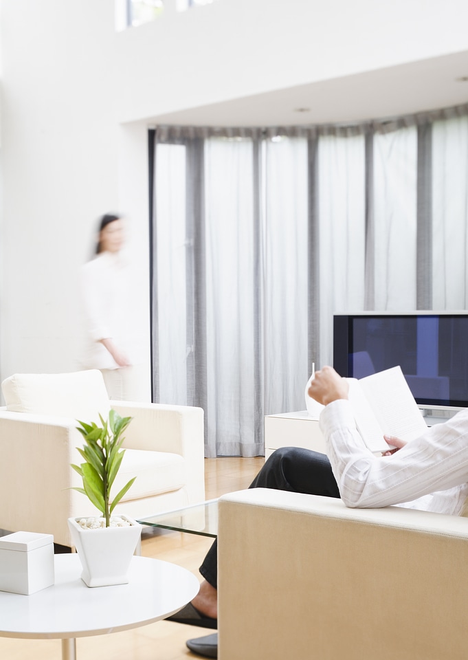 Rear view of caucasian man and woman relaxing at home