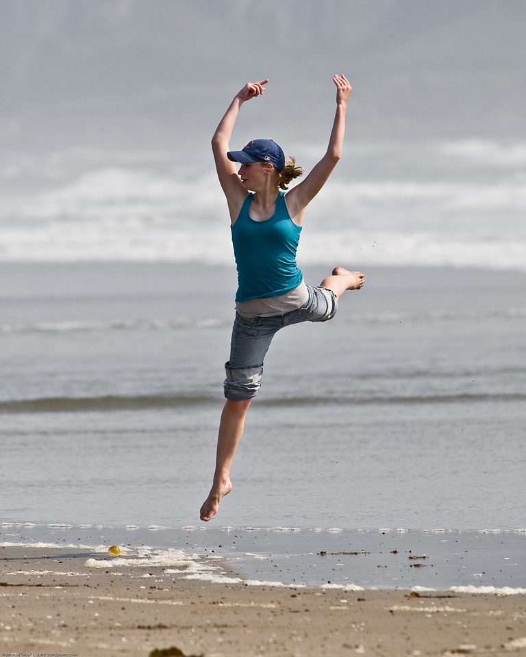 A Girl Jumping On The Beach