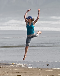 A Girl Jumping On The Beach photo