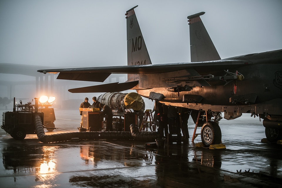 Propulsion technicians service an F-15E Strike Eagle engine