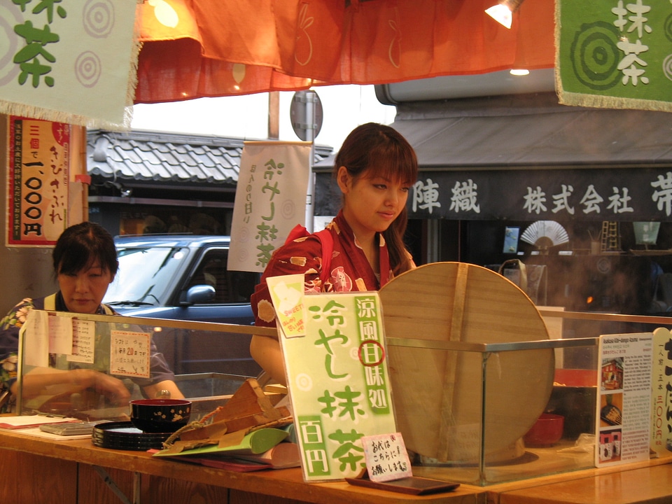 Japanese woman sits in her food shop