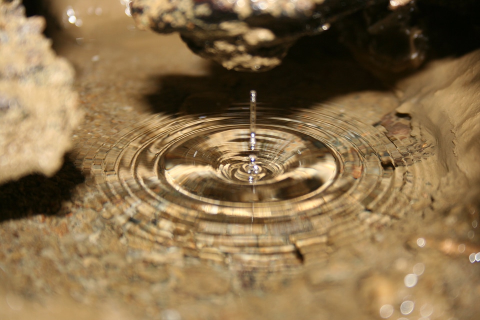 Water drops into a cave pool