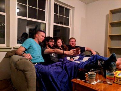 Group taking selfie on couch photo