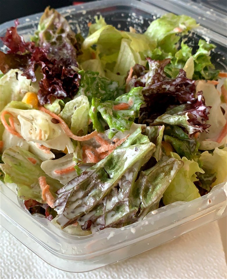 fresh greens with cucumbers, corn, carrots and César dressing