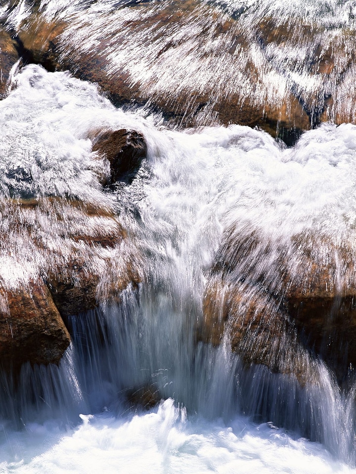 stones and mountain river with small waterfall, blurred backgroun
