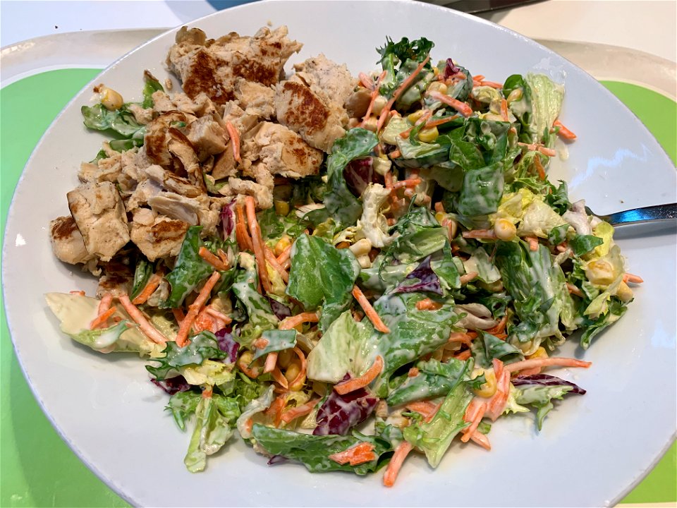 After 8 culinary specialities now a simple German green salad with carrots, cucumbers, corn, chicken and extra bread served with César dressing.