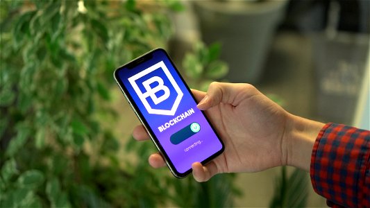 Man connecting to a blockchain platform with a smartphone