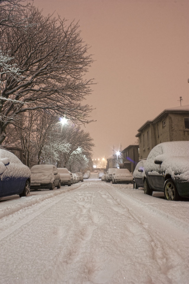 Snowy street in golden sunlight after storm