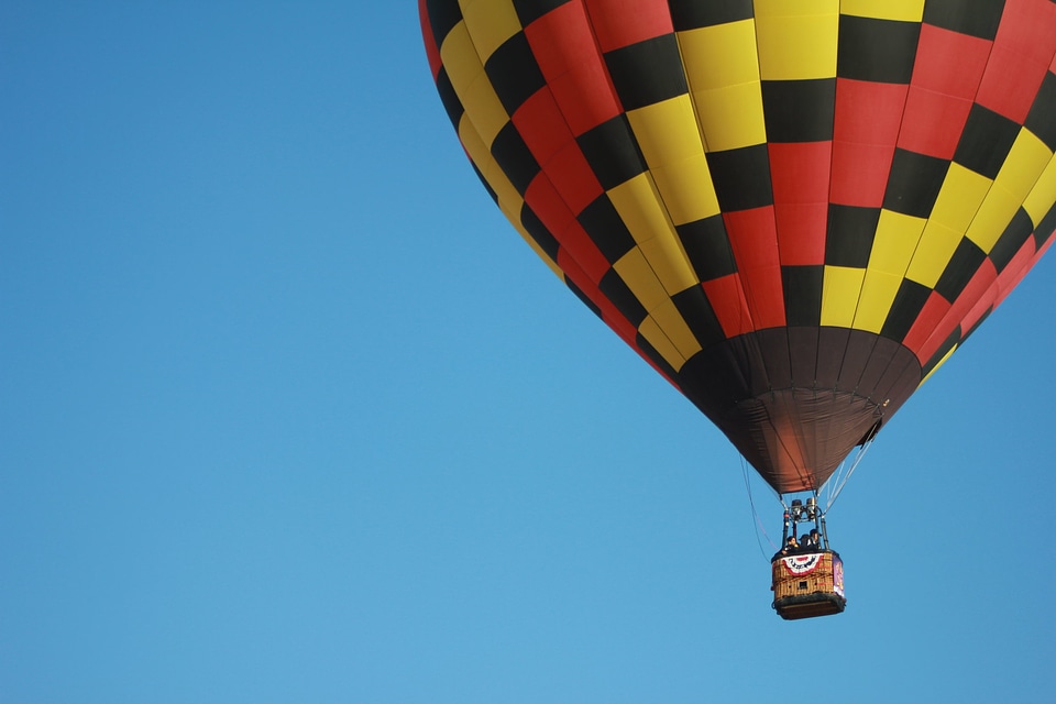 Colorful hot air balloons flying over mountain