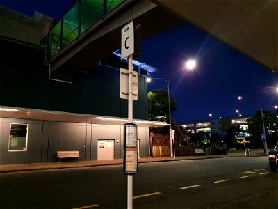 Bus stop sign in Ariki Street, Ngāmotu New Plymouth at night photo