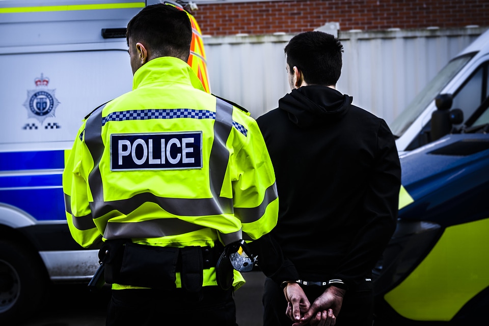 Police Officer Arresting Young Man photo