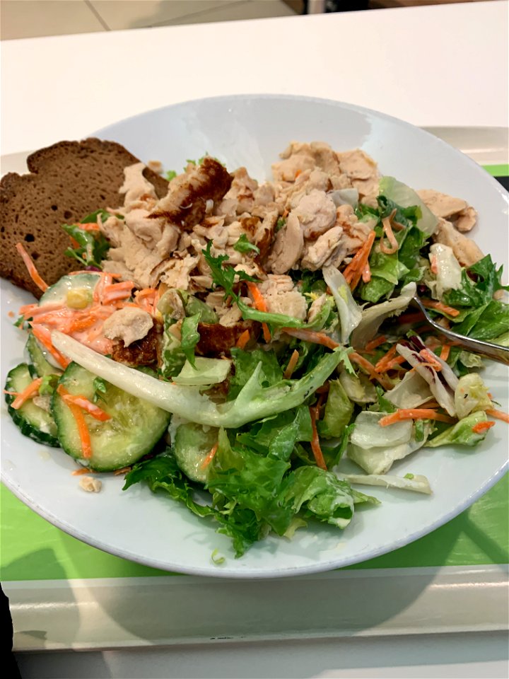 After 8 culinary specialities now a simple German green salad with carrots, cucumbers, corn, chicken and extra bread served with César dressing.