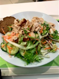 After 8 culinary specialities now a simple German green salad with carrots, cucumbers, corn, chicken and extra bread served with César dressing. photo