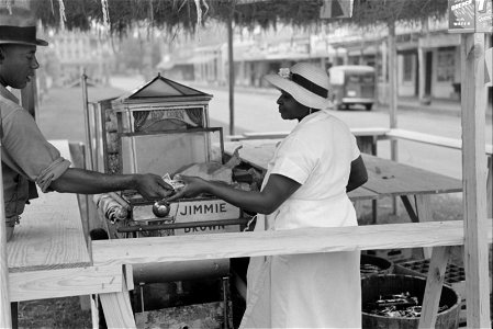 Paying for supplies delivered to concession, National Rice Festival, Crowley, Louisiana. Historic image.