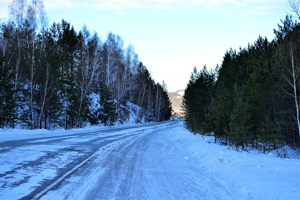 winter road along the river and mountains photo