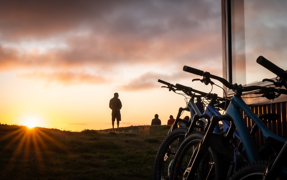 A group of people meet the sunrise at the peak of the mountain