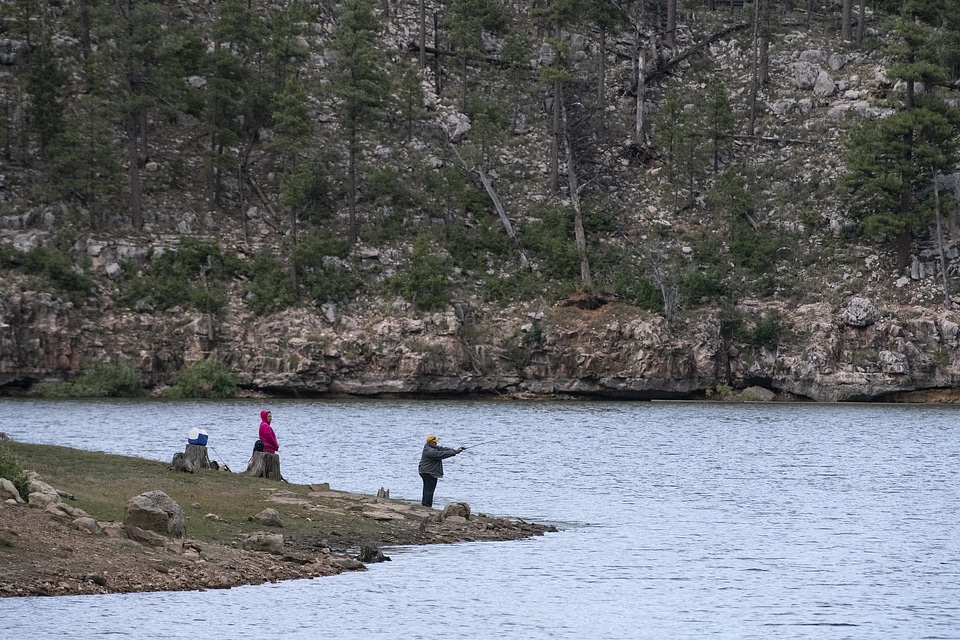 American man fly fishing in a river