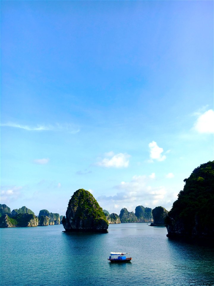 Ha Long Bay Vietnam single boat on water photo