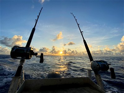 Fishing rods boat sunsrise photo