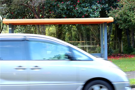 Car drives past bus shelter in Ngāmotu New Plymouth, Taranaki, New Zealand photo