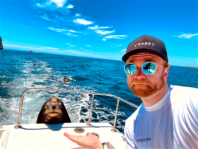 devin schumacher on a boat with seal the seal-flip