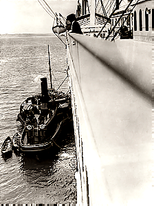 Tug America along side the Titanic at Cobh