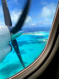 prop plane landing tropical island photo