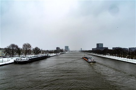 Binnenvaartschepen op het Amsterdam-Rijnkanaal in besneeuwd Utrecht photo
