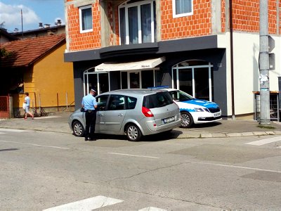 Policeman punishes driver because of prohibited parking on pavement, Banja Luka, Bosnia and Herzegovina
