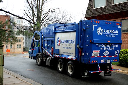 Truck 167 moving a recycling dumpster