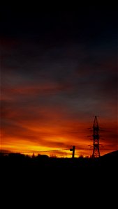 Sunset behind power lines photo