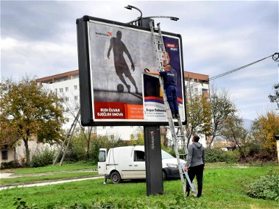 A day after local elections in Banja Luka: Workers remove pre-election billboard with councilor candidates and stick new, non-political advertisement
