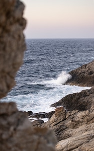Waves crashing onto rocks photo