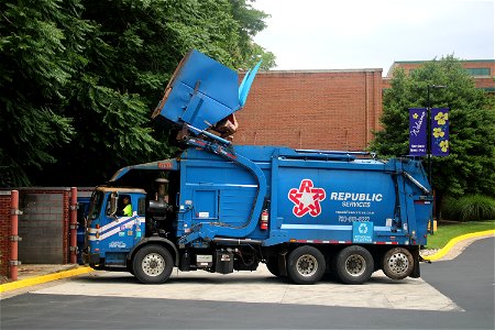 Republic Services truck 1354 emptying a recycling dumpster photo