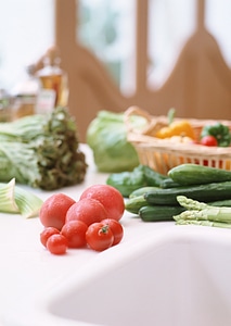 Red tomatos on vegetable background photo