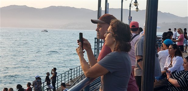 Women Photographs Sunset off Santa Monica Pier